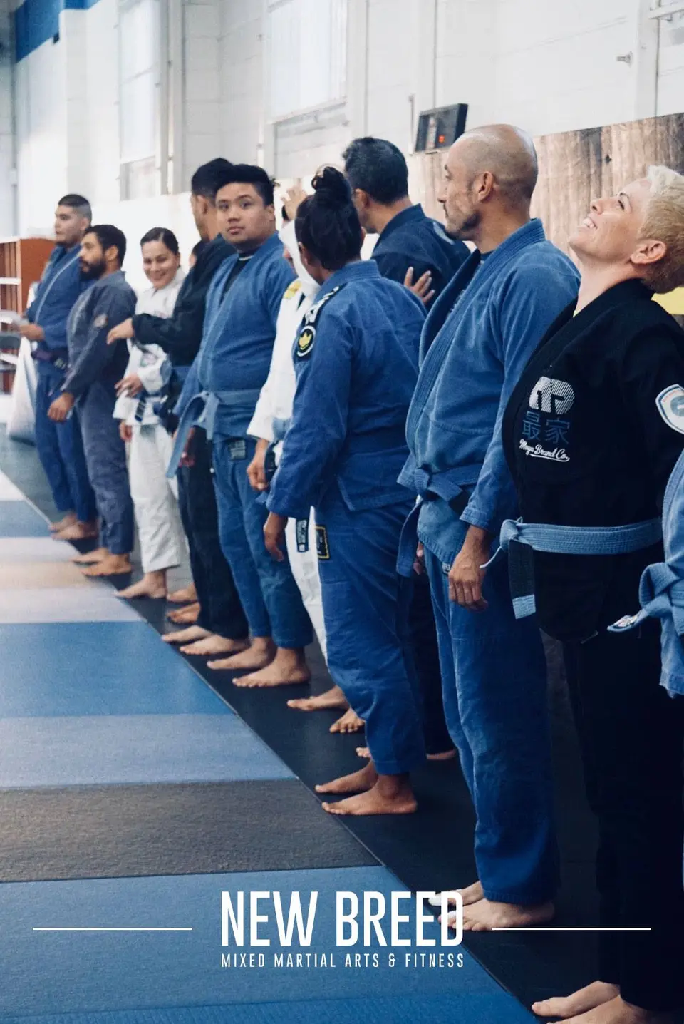 Students in gis lined up by belt rank